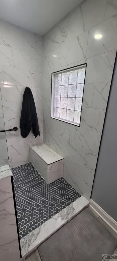 JDSBath VA Grant veteran bathroom remodel full wall tile around window bench towel hook low threshold glen allen va