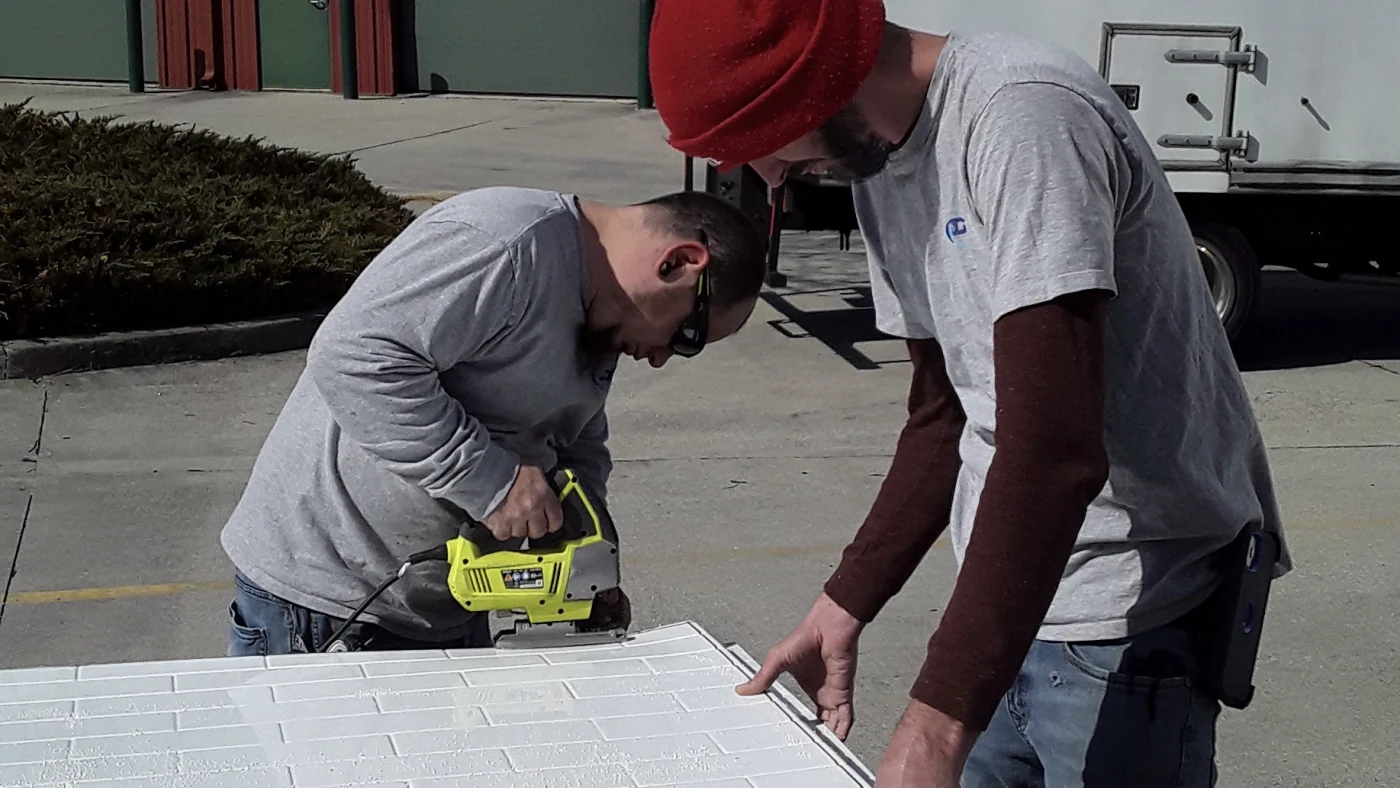 JDS Bath employees cut tile for Richmond, VA  shower wall surround