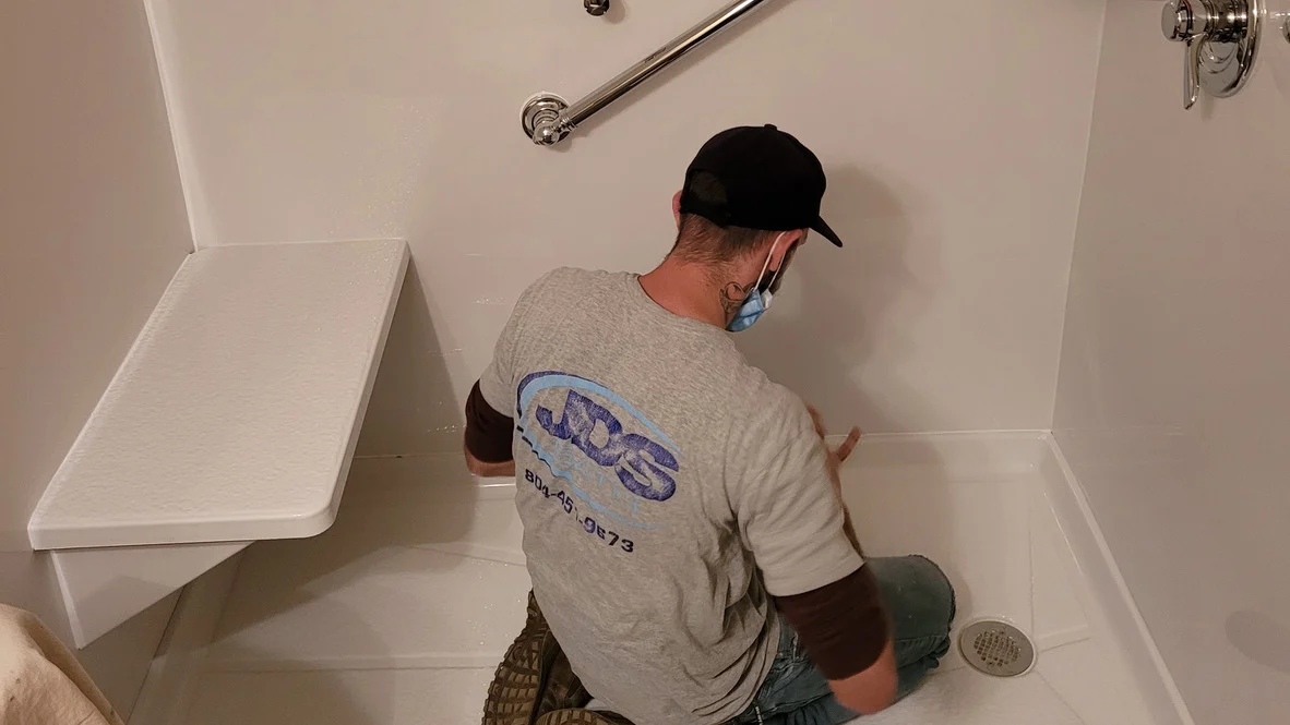JDS Bath employee installs new handicap accessible shower