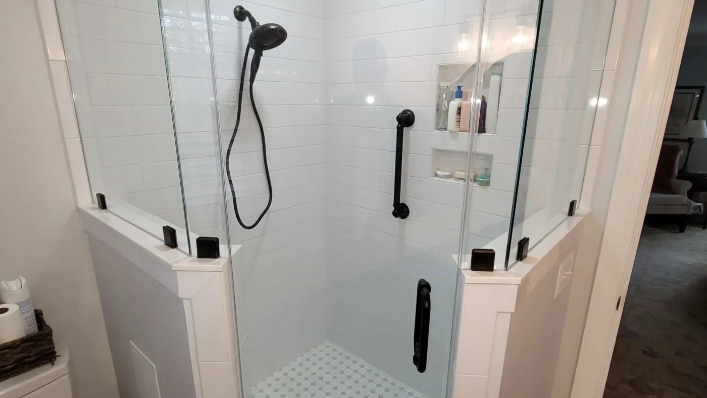 A neo-angle tile shower with custom glass panels and doors