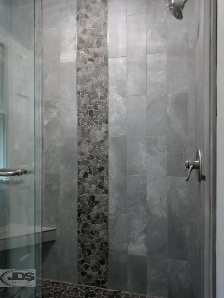 After photo of new shower from the left side showing glass doors with shower bar.