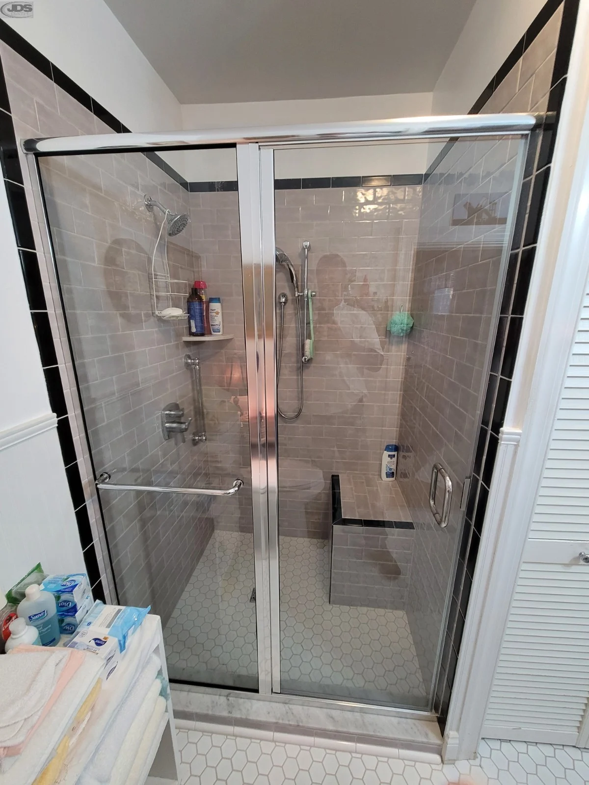 Chrome framed clear shower door installed during bathroom remodel
