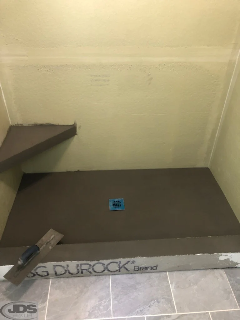 Shower floor and corner shelf before.