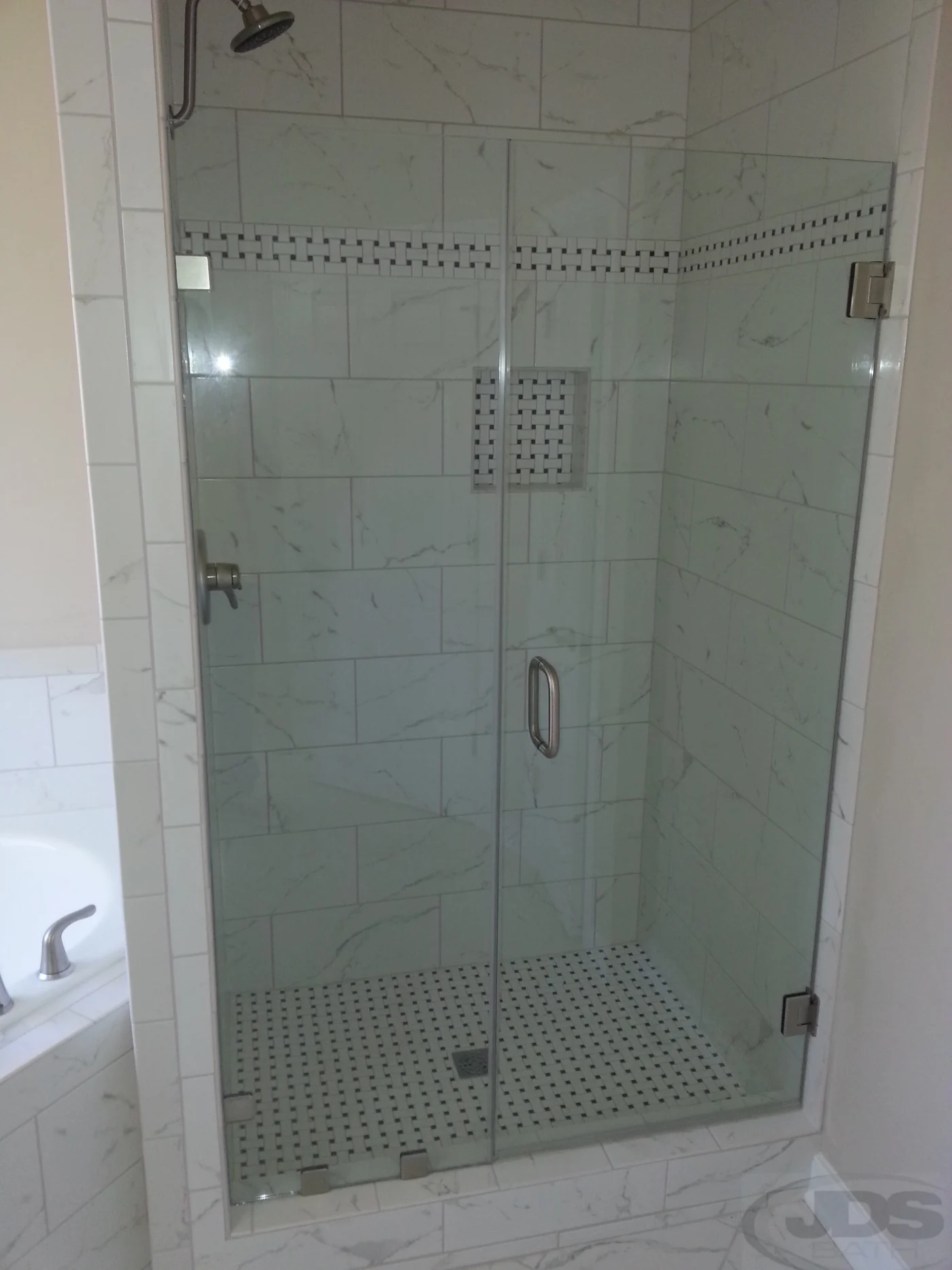 A picture of frameless shower door and panel in Central Virginia