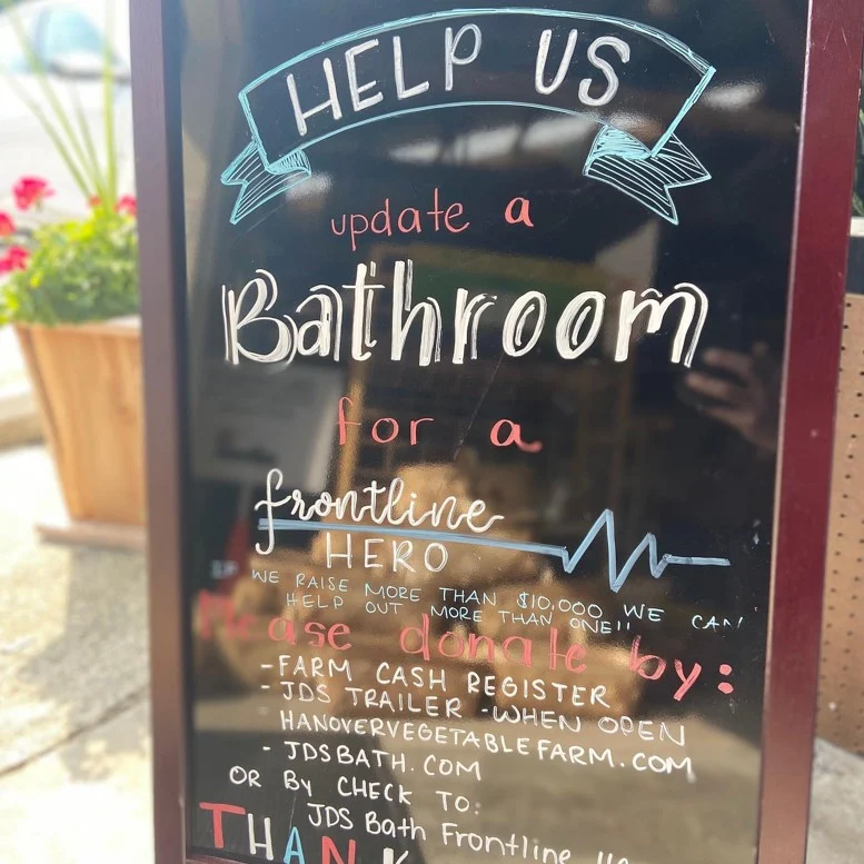 Closeup of a sign reading, “Help is updating a bathroom for a frontline hero.”