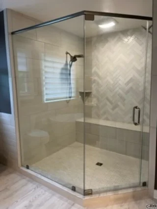 An image of large neo-angle frameless shower door and panels