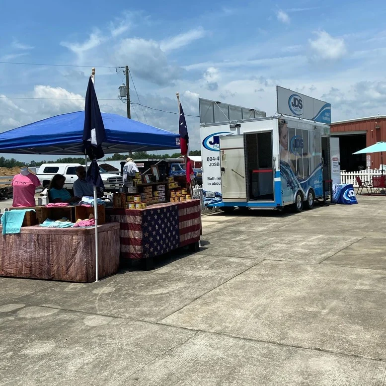 Outdoor fundraiser stand and JDS truck.