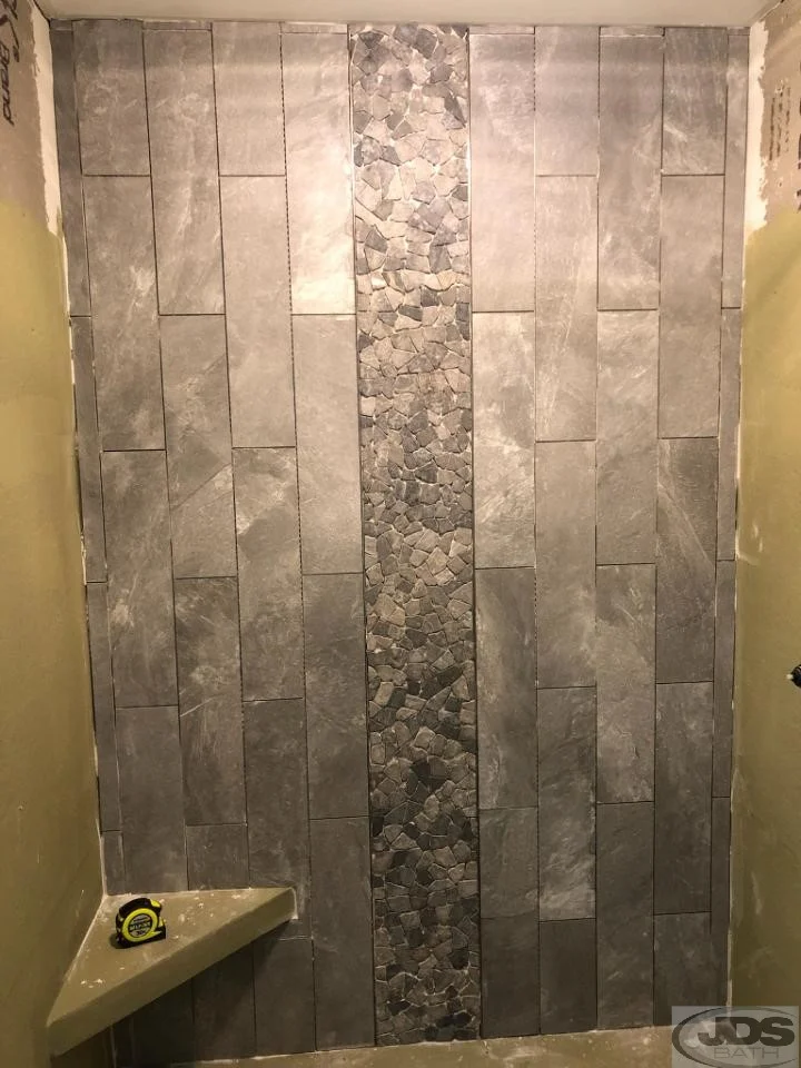 Installing slate and stone shower wall.