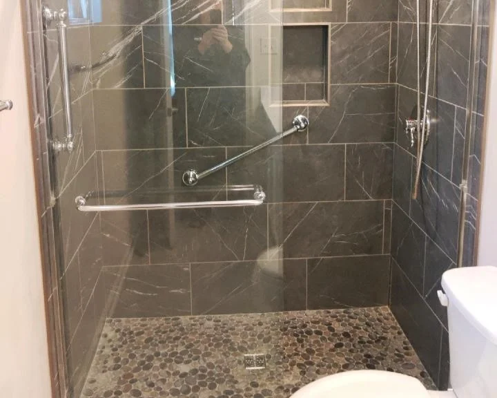 Remodeled walk-in shower with a tile wall surround