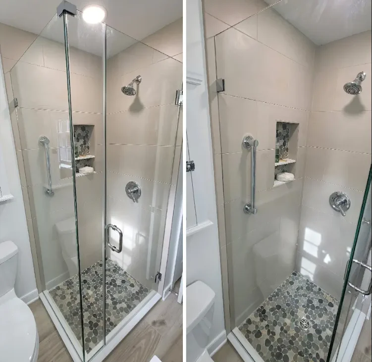 Corner shower with glass doors and river rock detail on floor