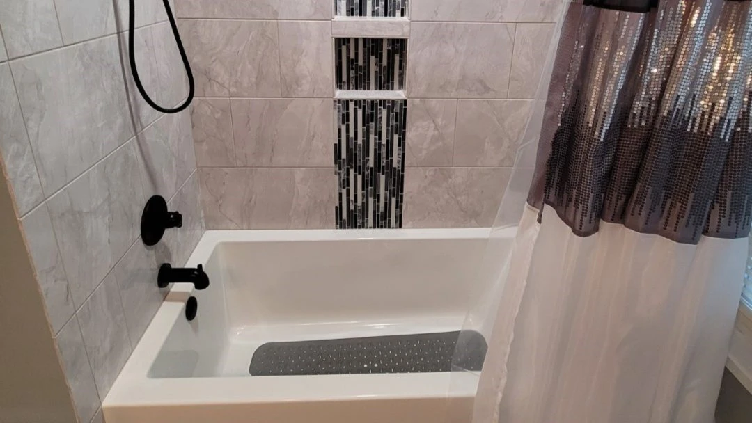 An acrylic bathtub with a tile surround in central Virginia by JDS Bath