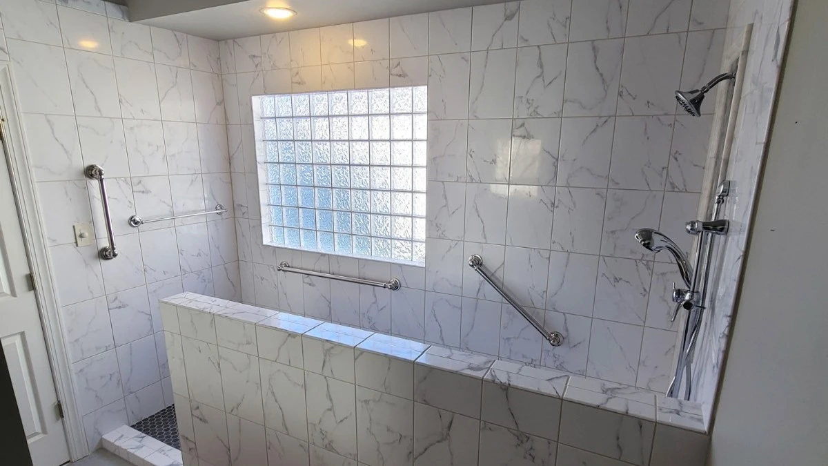 Accessible walk-in shower with beautiful tile and frosted window
