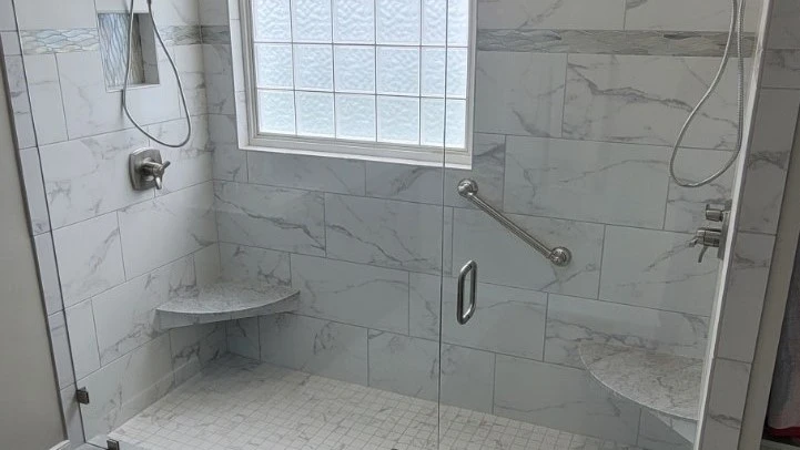 New walk-in shower with frosted glass window and beautiful tile job