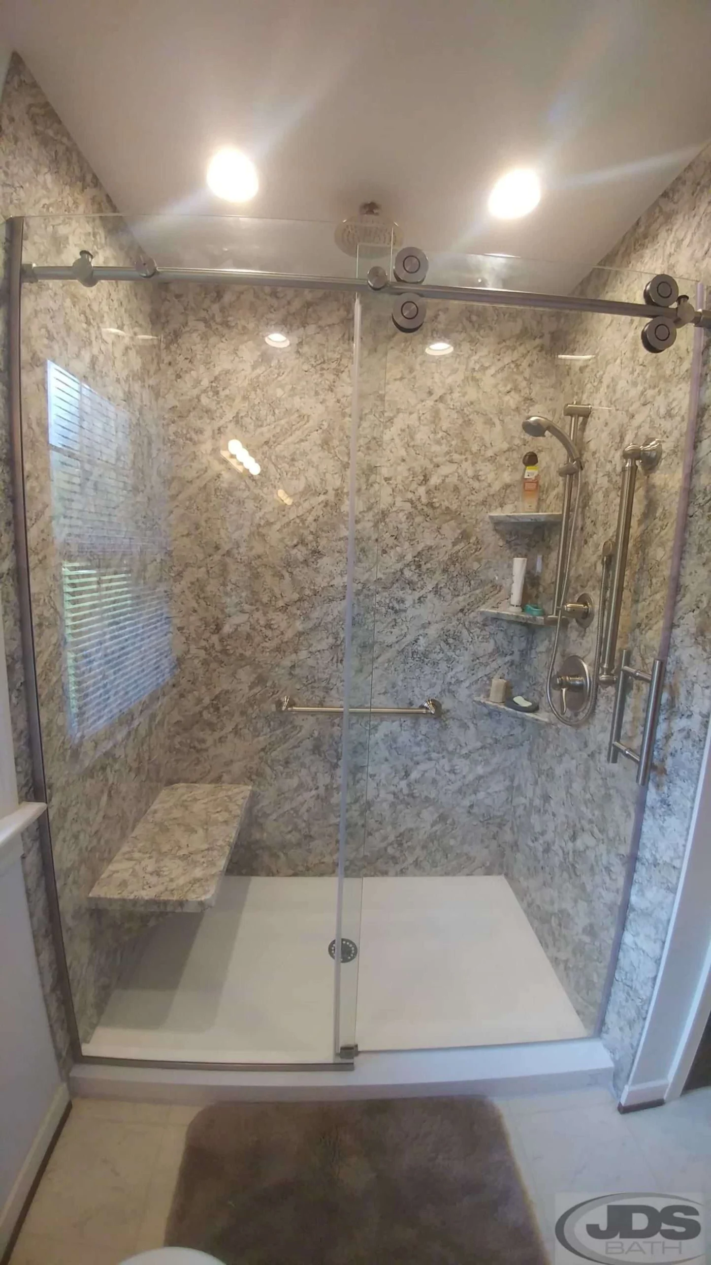 Large acrylic faux marble walk-in shower with bench