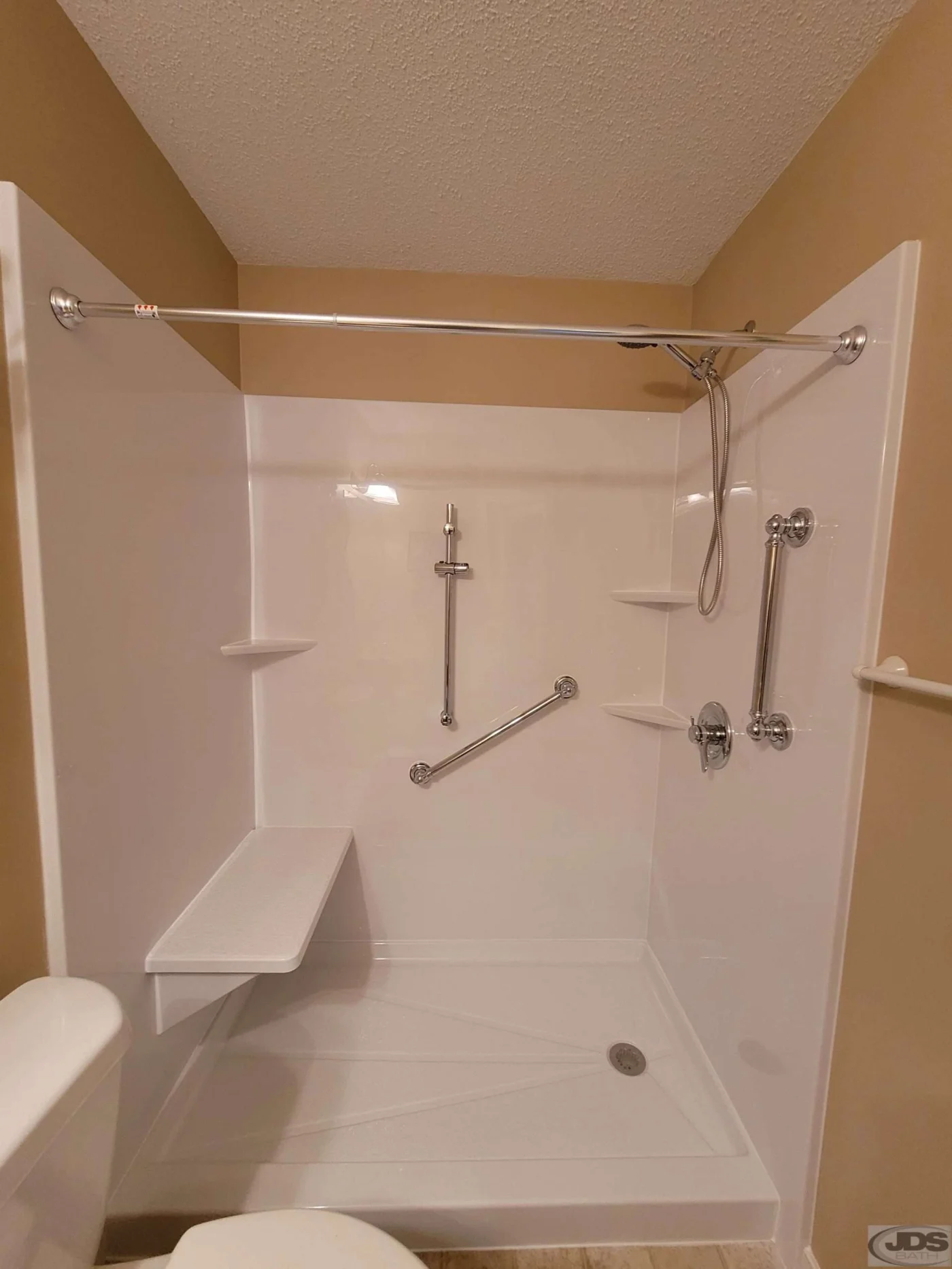 All white acrylic shower with grab bars