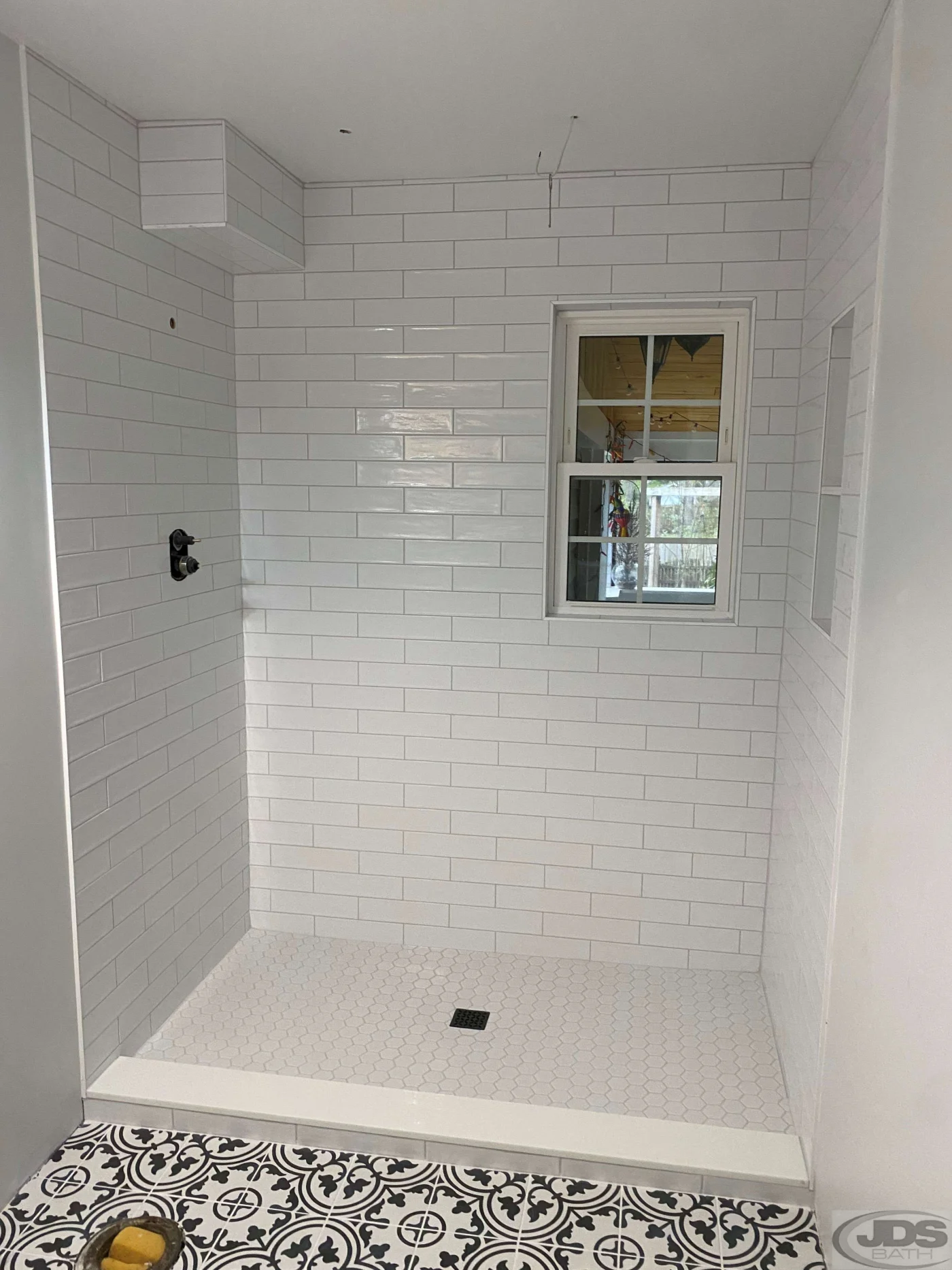 A picture of a modern new shower in a smaller bathroom, maximizing space.