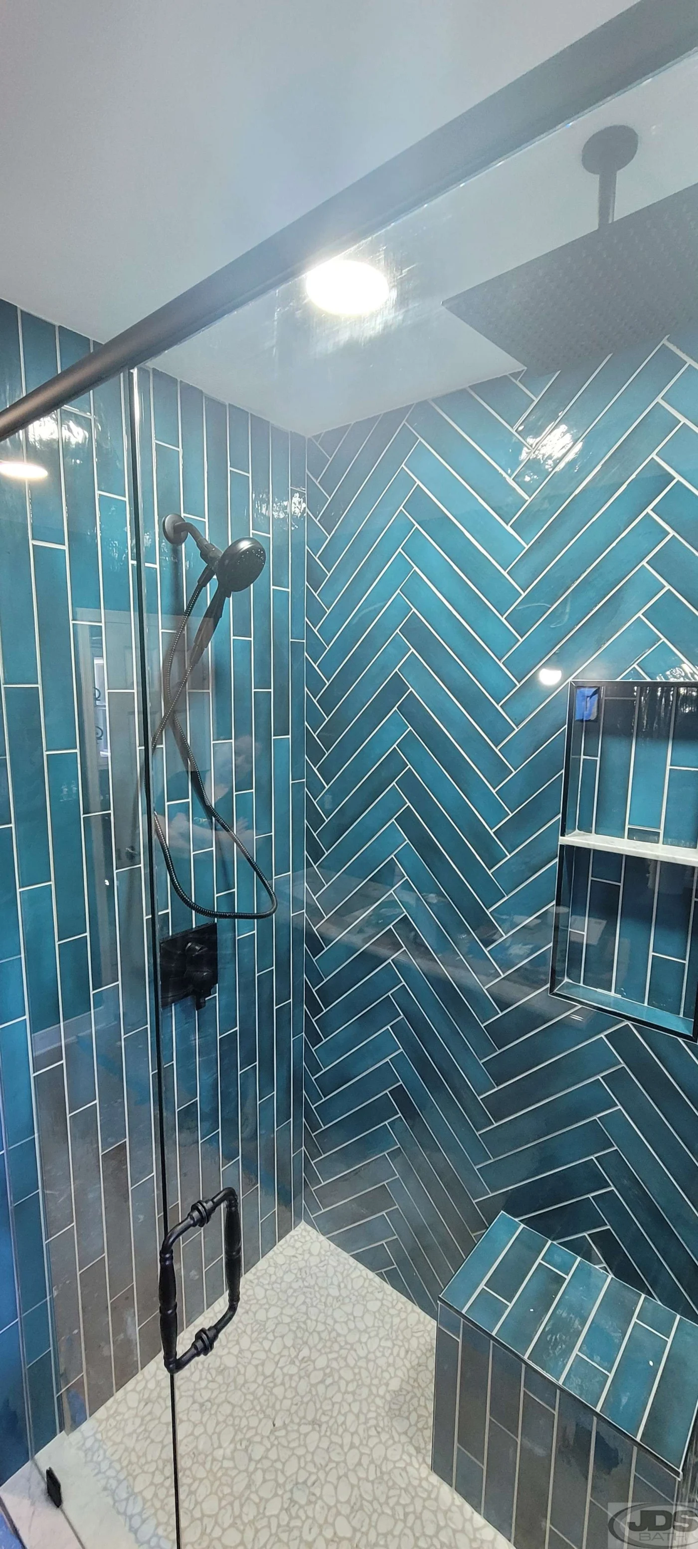 A clean tub to shower conversion with frameless glass doors.