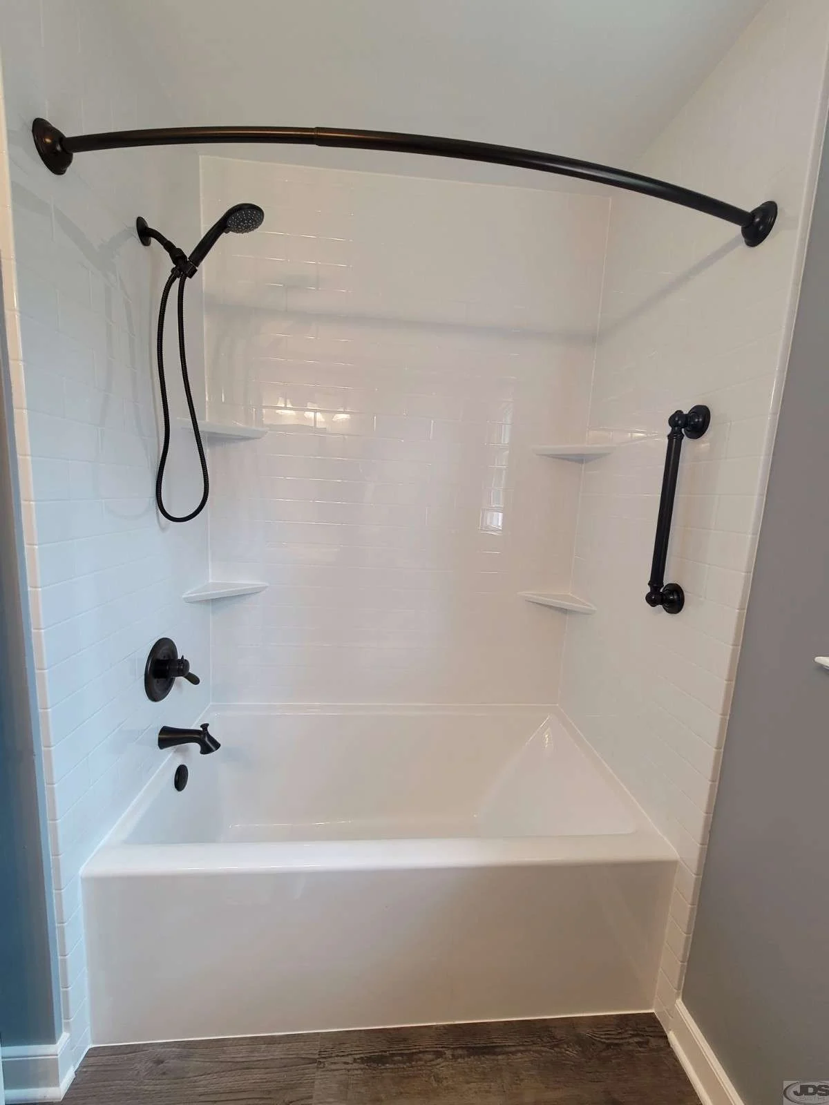 A refined tub-to-shower conversion creates a sleek, easy-to-maintain space.