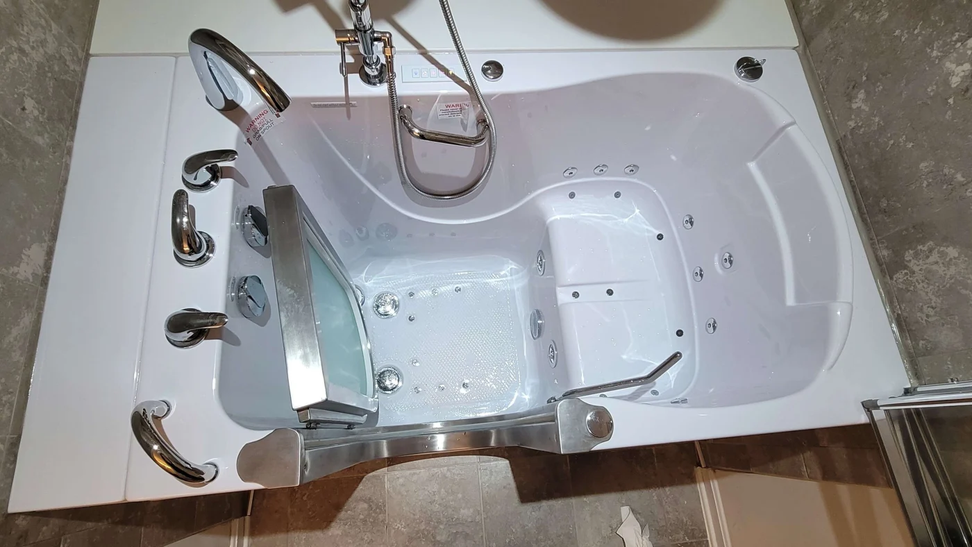 A view looking down at a bathtub with many accessories.